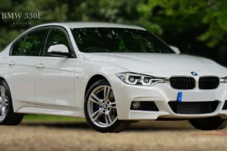 White BMW 330e plug-in hybrid sedan parked outdoors, showcasing sleek design and performance in this BMW 330e review.
